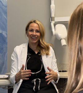 Dr LeClere smiling while explaining to her patient