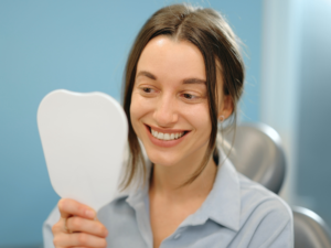 Happy woman admiring her smile during a dental visit as a new patient